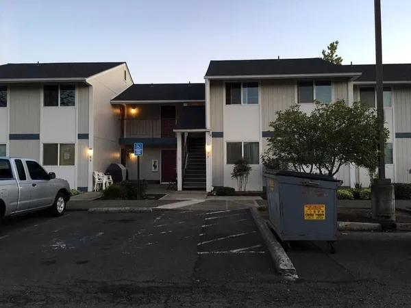 a front view of small house with entryway and outdoor seating