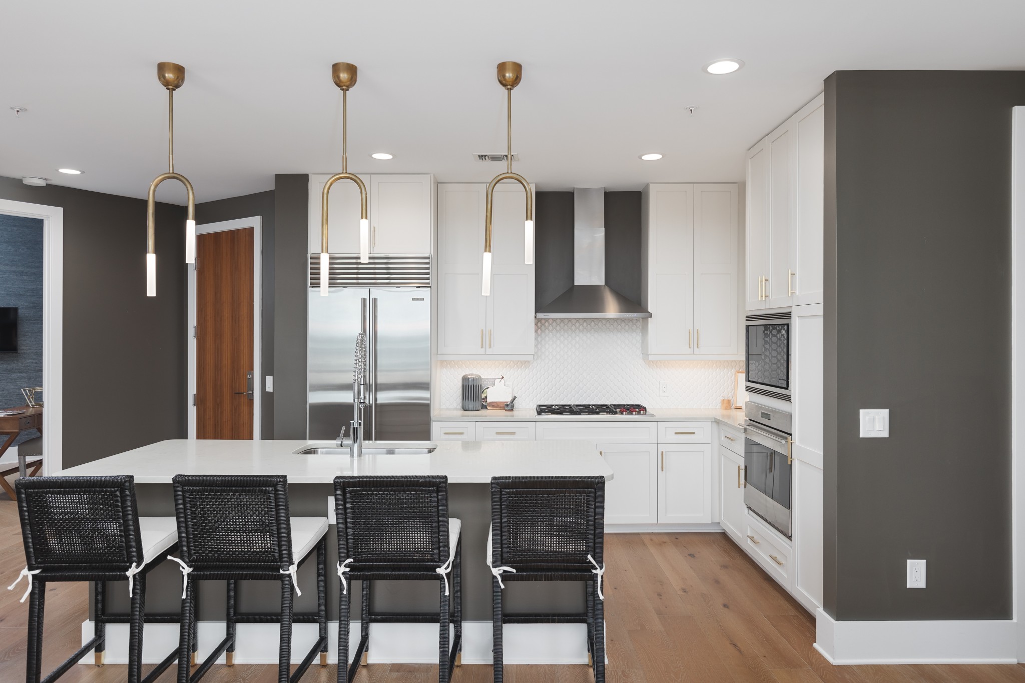 20 Rutledge Street, Unit 505 Nashville, TN 37210 - Photo 2 of 67 a kitchen with granite countertop a dining table chairs and white cabinets