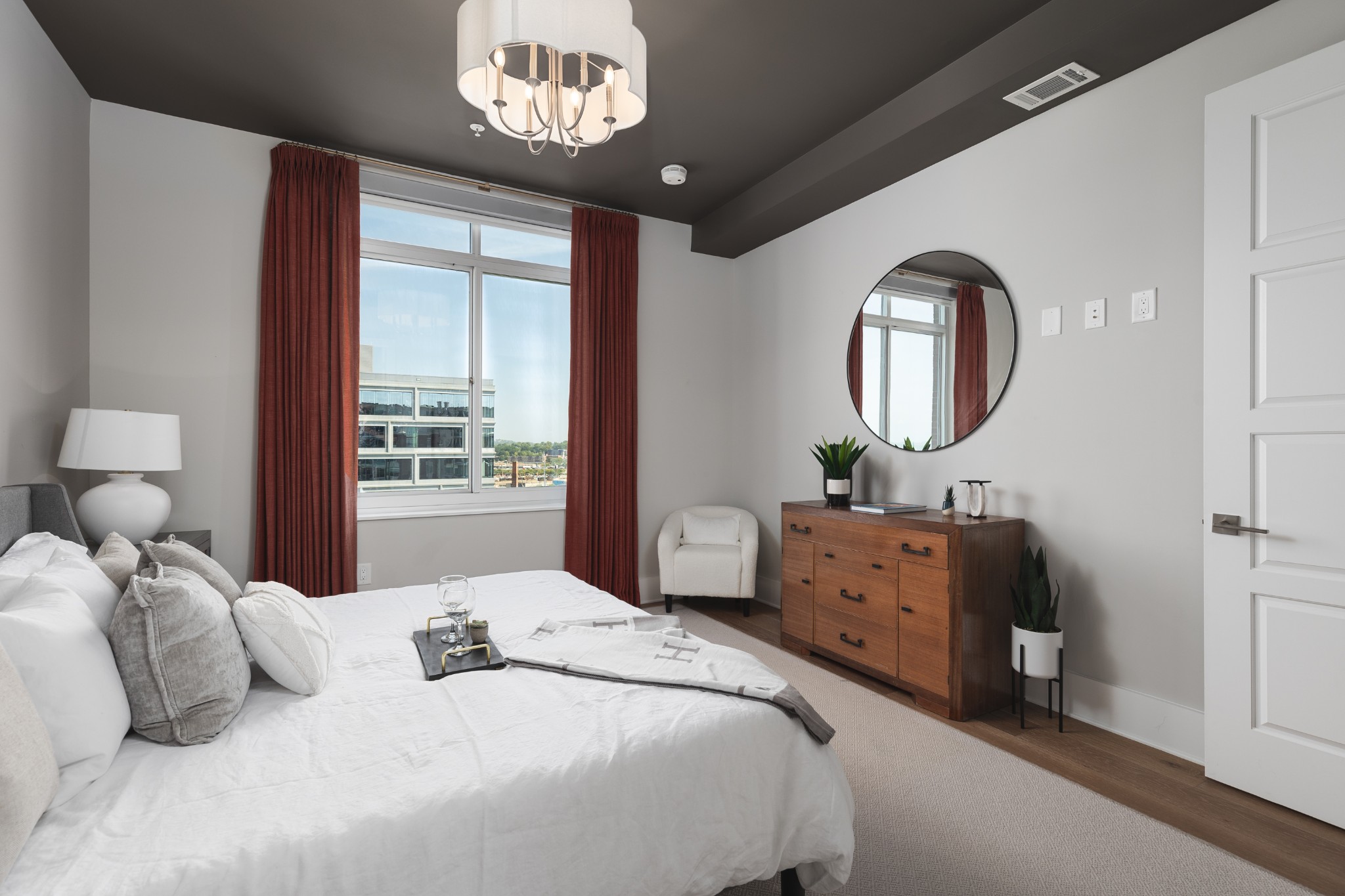 20 Rutledge Street, Unit 505 Nashville, TN 37210 - Photo 21 of 67 a bedroom with a bed and a large mirror on the dresser