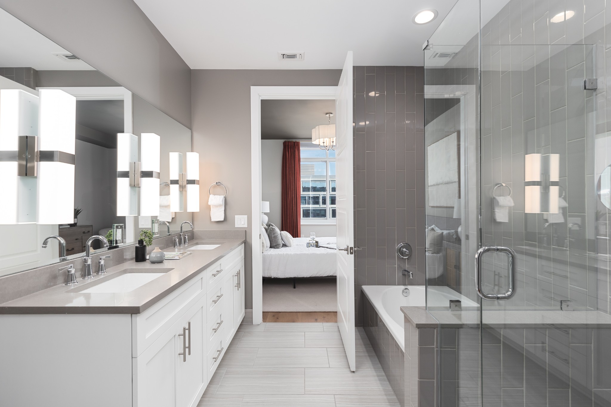20 Rutledge Street, Unit 505 Nashville, TN 37210 - Photo 24 of 67 a bathroom with a granite countertop double vanity sink a large mirror and a bathtub