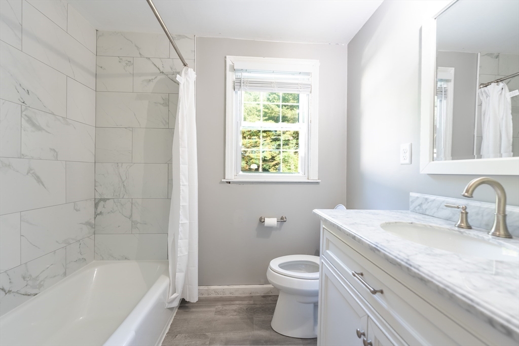 54 Chisholm Road Stoughton, MA 02072 - Photo 11 of 33 a bathroom with a granite countertop sink toilet and shower