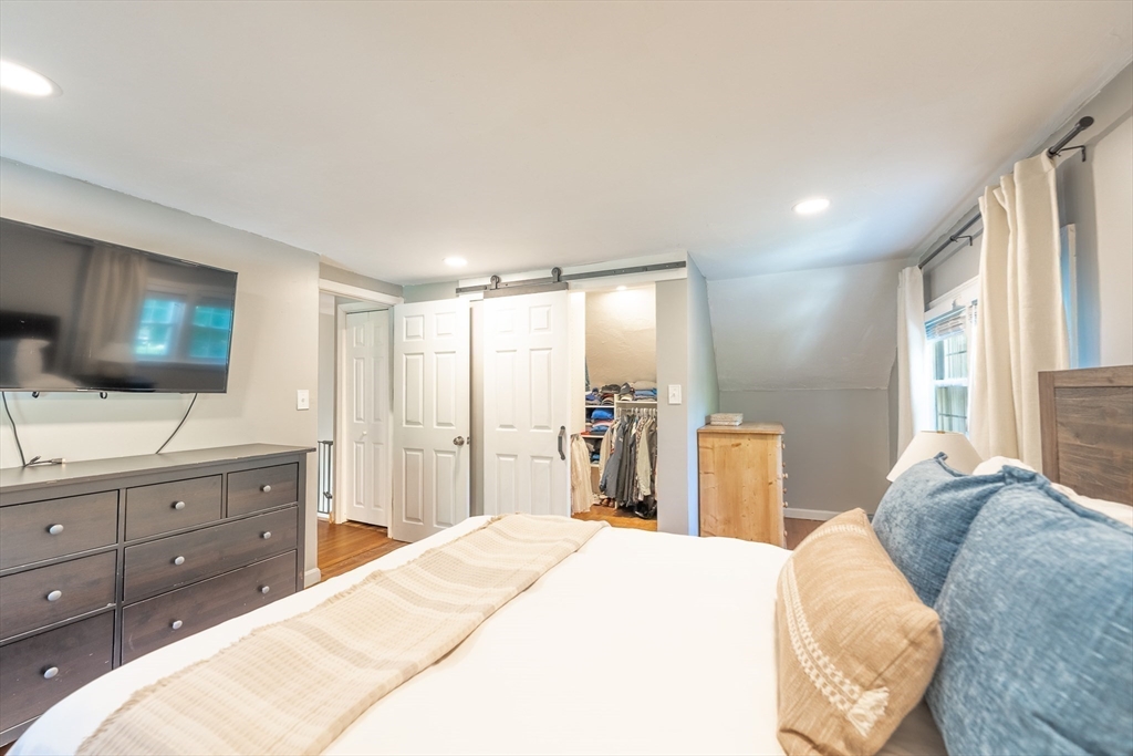 54 Chisholm Road Stoughton, MA 02072 - Photo 16 of 33 a bedroom with a bed and a flat screen tv