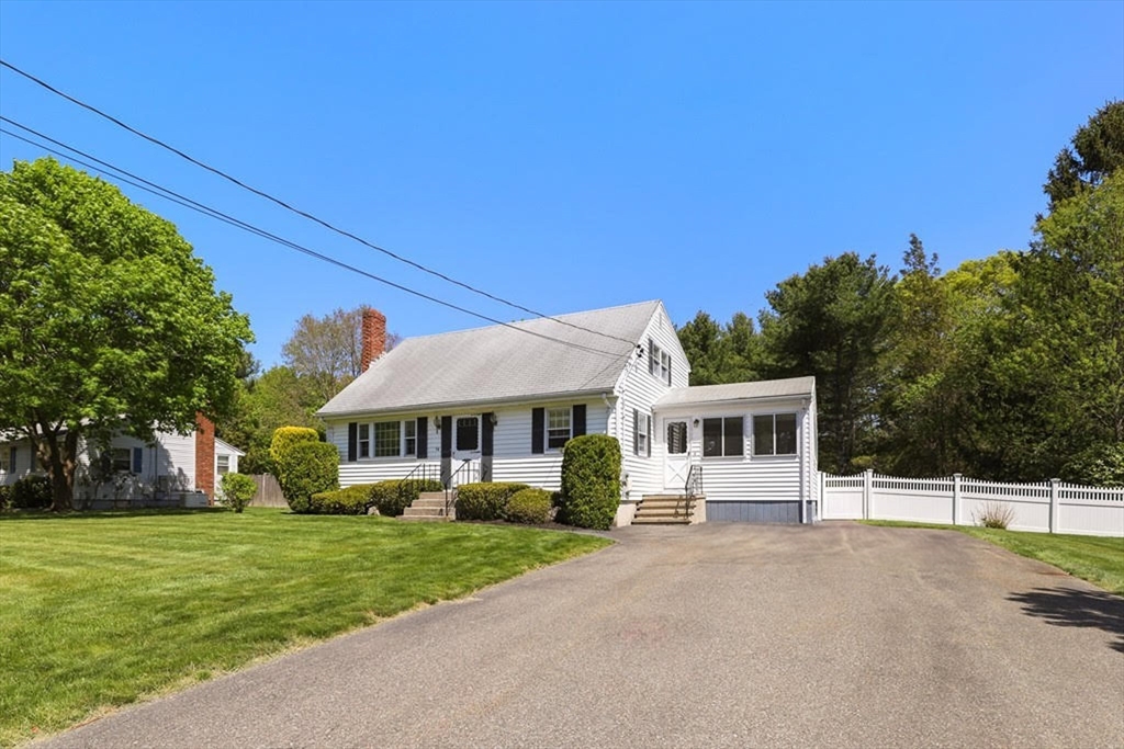 54 Chisholm Road Stoughton, MA 02072 - Photo 2 of 33 a front view of a house with a yard