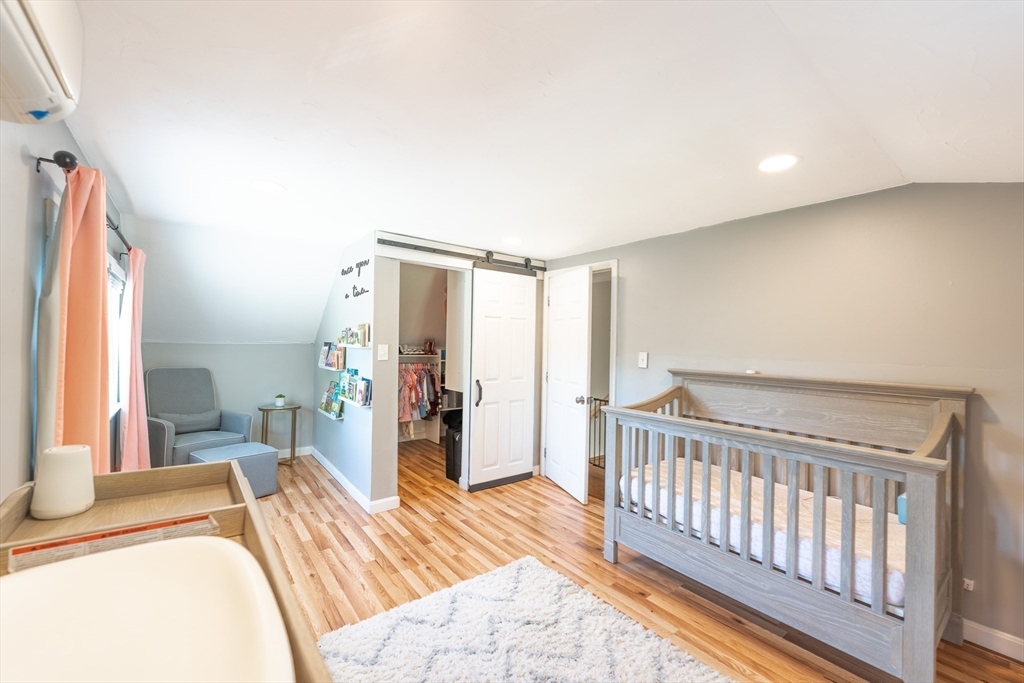 54 Chisholm Road Stoughton, MA 02072 - Photo 22 of 33 a bedroom with a bed and a large window