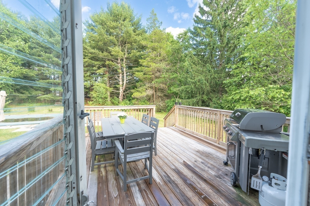 54 Chisholm Road Stoughton, MA 02072 - Photo 30 of 33 a view of a balcony with table and chairs and wooden floor