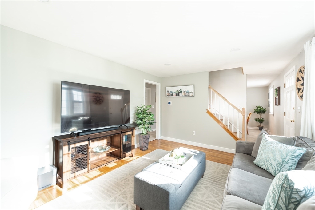 54 Chisholm Road Stoughton, MA 02072 - Photo 9 of 33 a living room with furniture and a flat screen tv