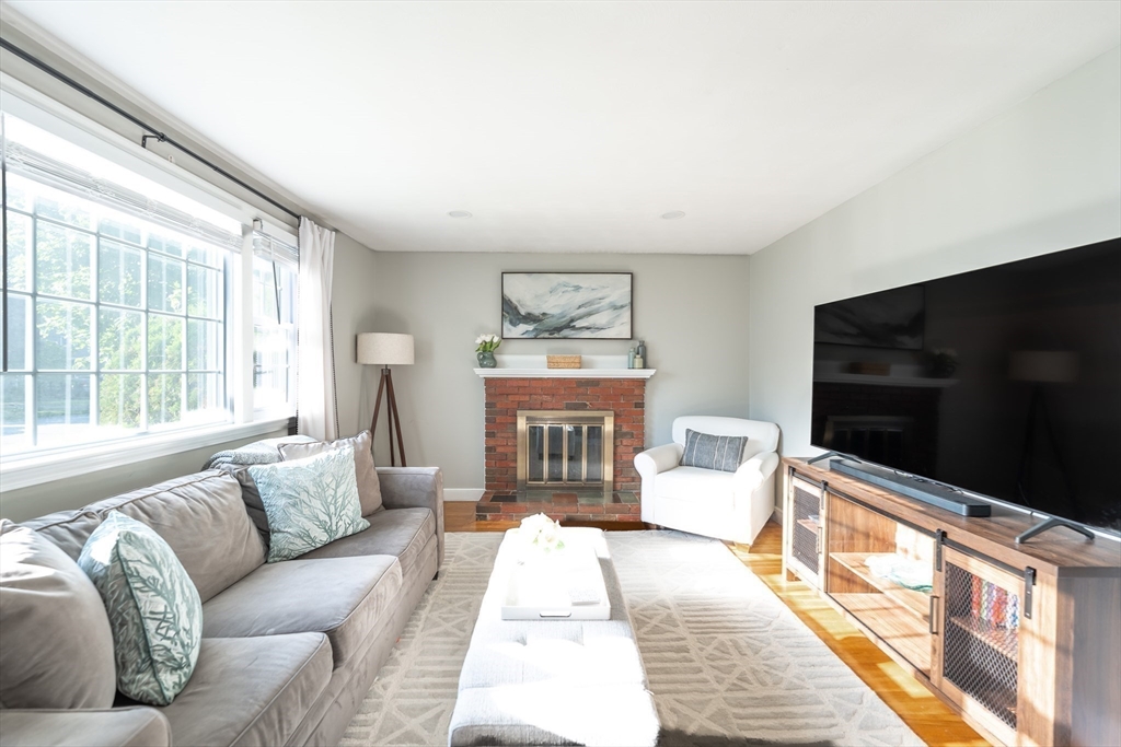 54 Chisholm Road Stoughton, MA 02072 - Photo 10 of 33 a living room with furniture flat screen tv and a large window