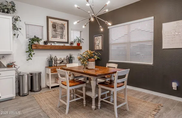 a kitchen with stainless steel appliances granite countertop a sink a stove a refrigerator and cabinets