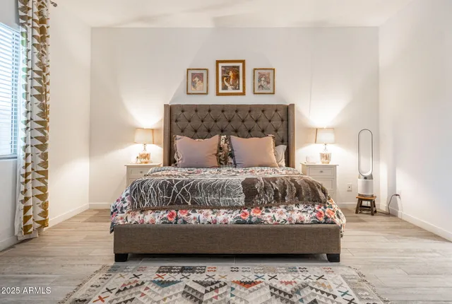 a bedroom with a large bed and a window