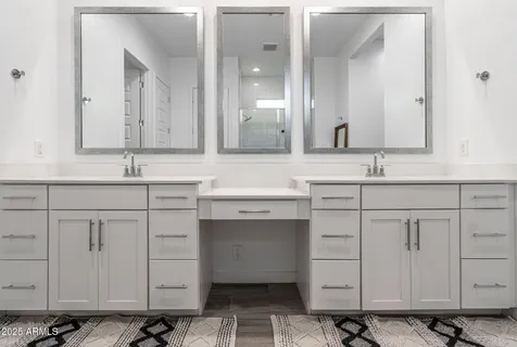 a bathroom with a double vanity sink mirror and double