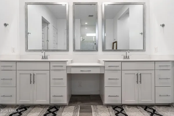 a bathroom with a double vanity sink mirror and double
