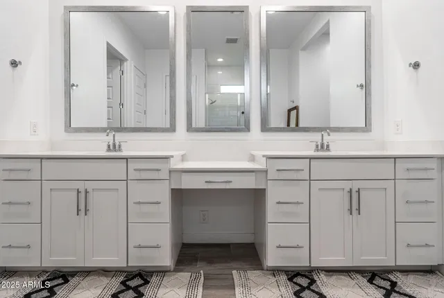 a bathroom with a double vanity sink mirror and double
