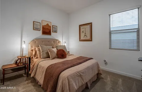 a bedroom with bed and window