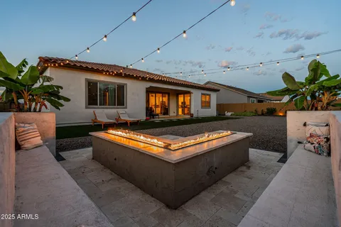 a view of a backyard with sitting area