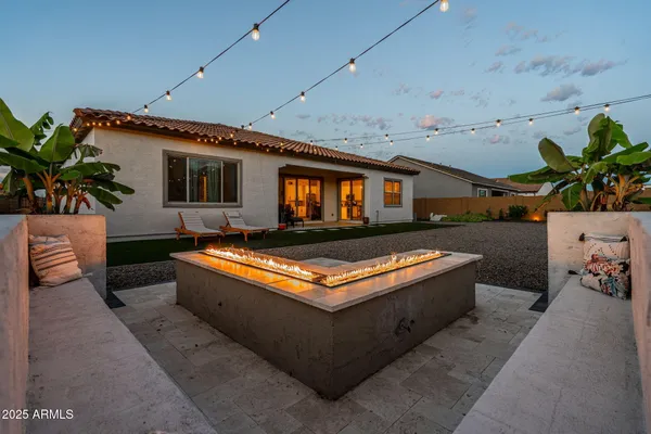 a view of a backyard with sitting area