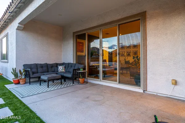 a backyard of a house with plants and palm trees