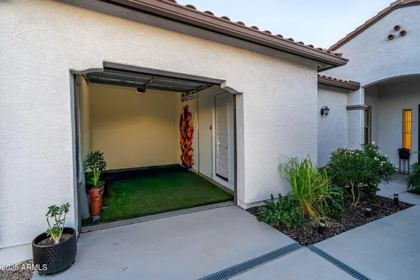 a view of a patio with table and chairs and floor to ceiling window