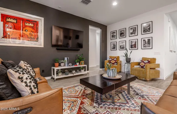 a living room with furniture and wooden floor