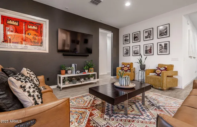 a living room with furniture and wooden floor