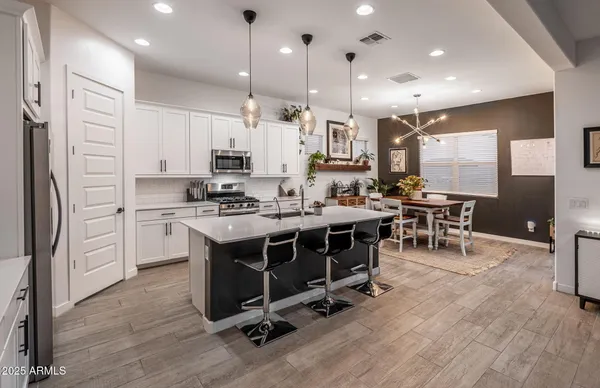 a living room with furniture and painting on the wall