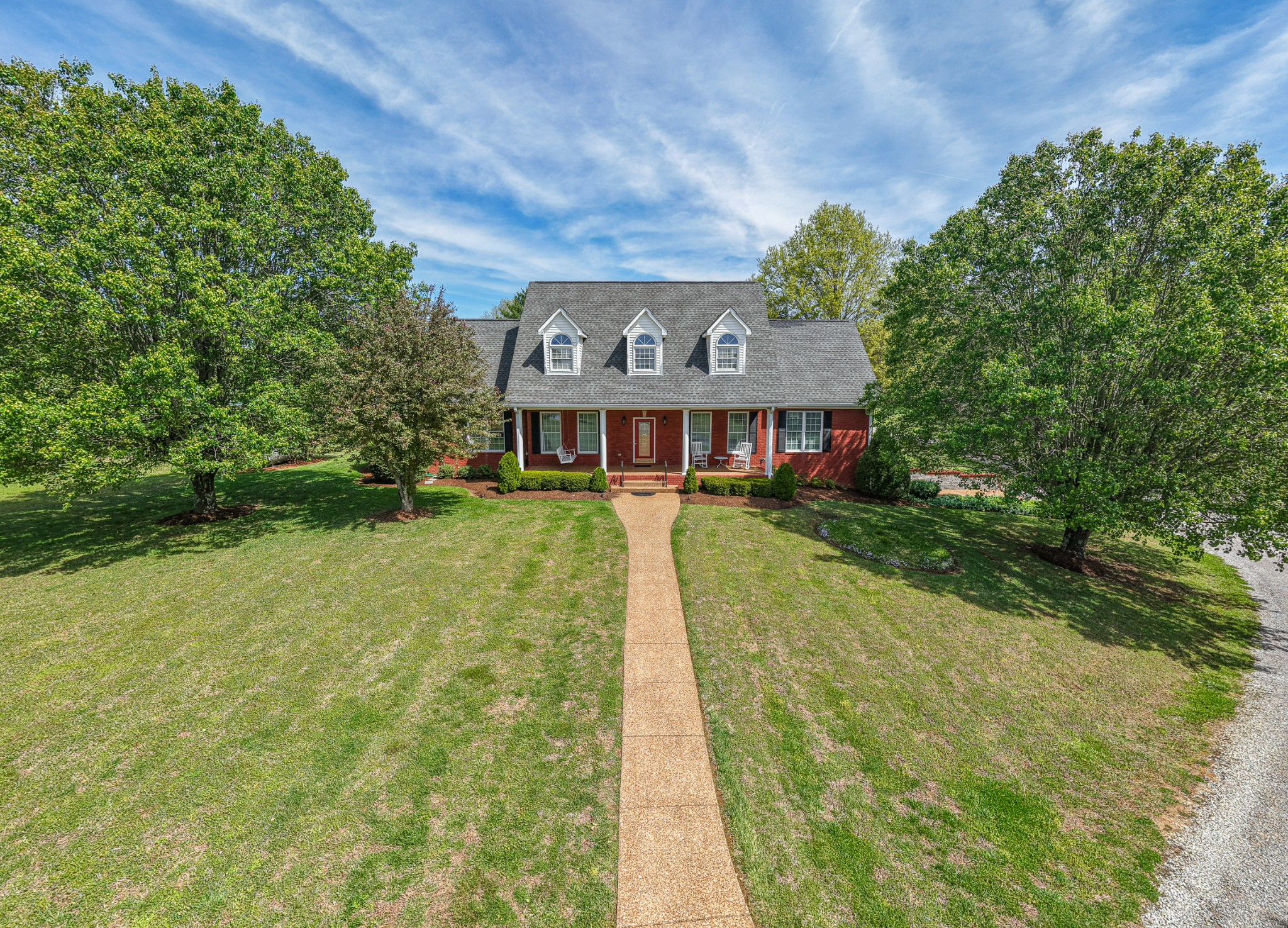 a view of swimming pool with a garden and plants