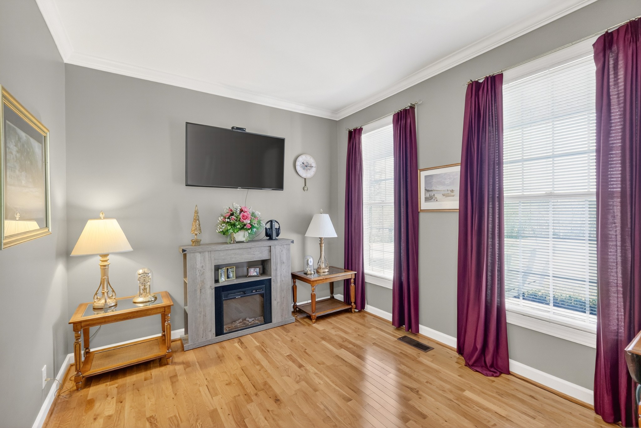 4676 Harpeth-Peytonsville Road Thompson's Station, TN 37179 - Photo 22 of 84 a living room with furniture a flat screen tv and a fireplace