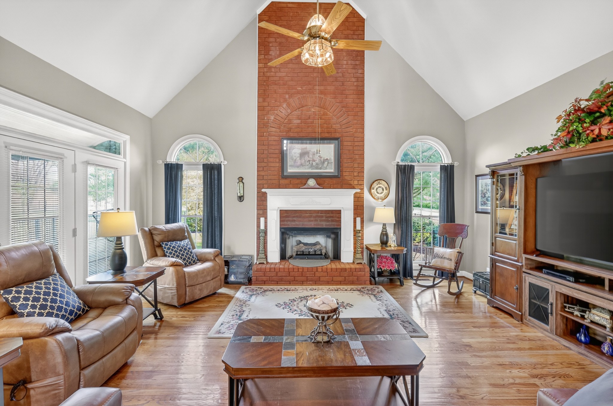 4676 Harpeth-Peytonsville Road Thompson's Station, TN 37179 - Photo 4 of 84 a living room with furniture a fireplace and a flat screen tv