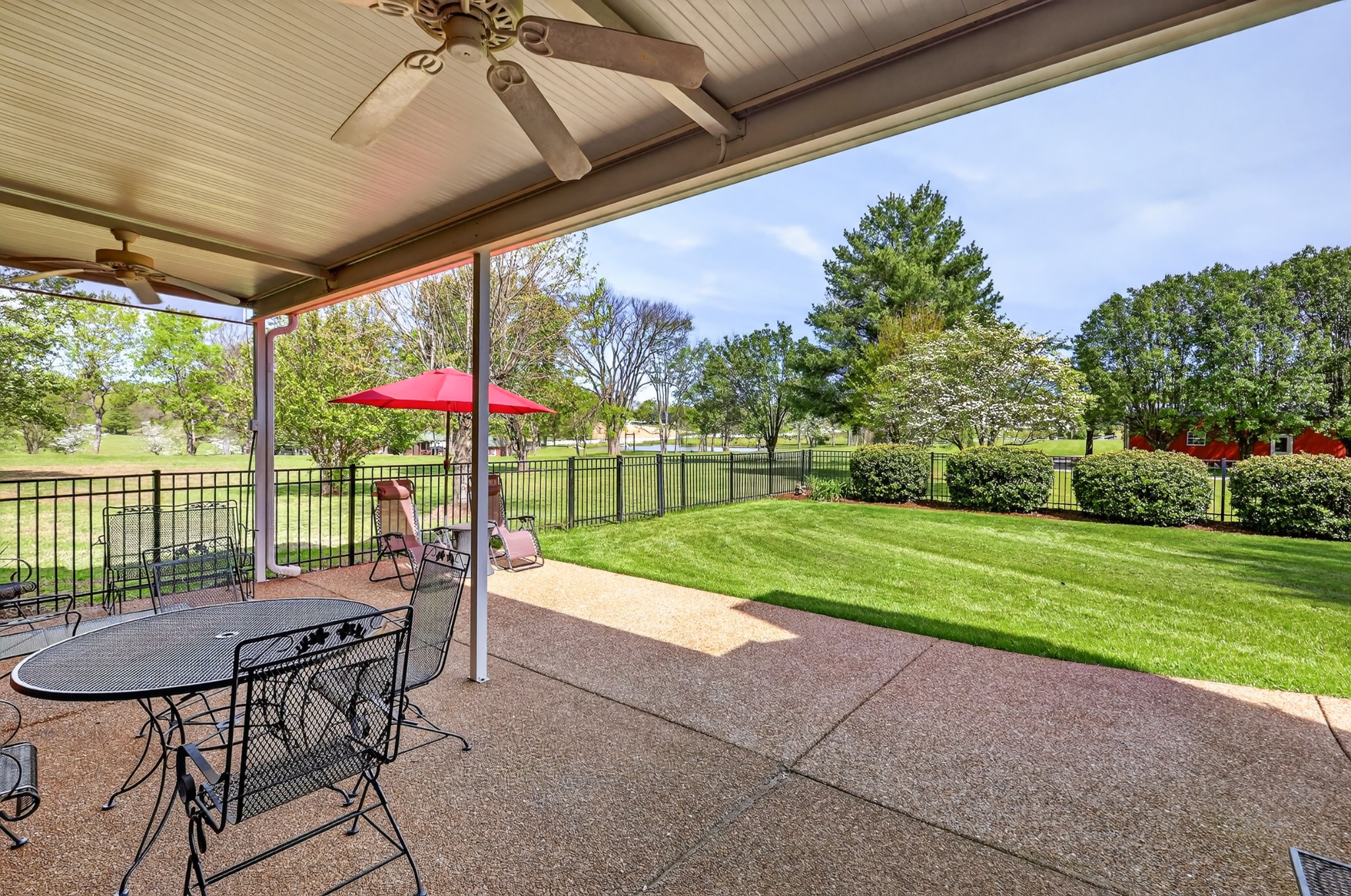 4676 Harpeth-Peytonsville Road Thompson's Station, TN 37179 - Photo 44 of 84 a view of a patio with a table chairs and a yard