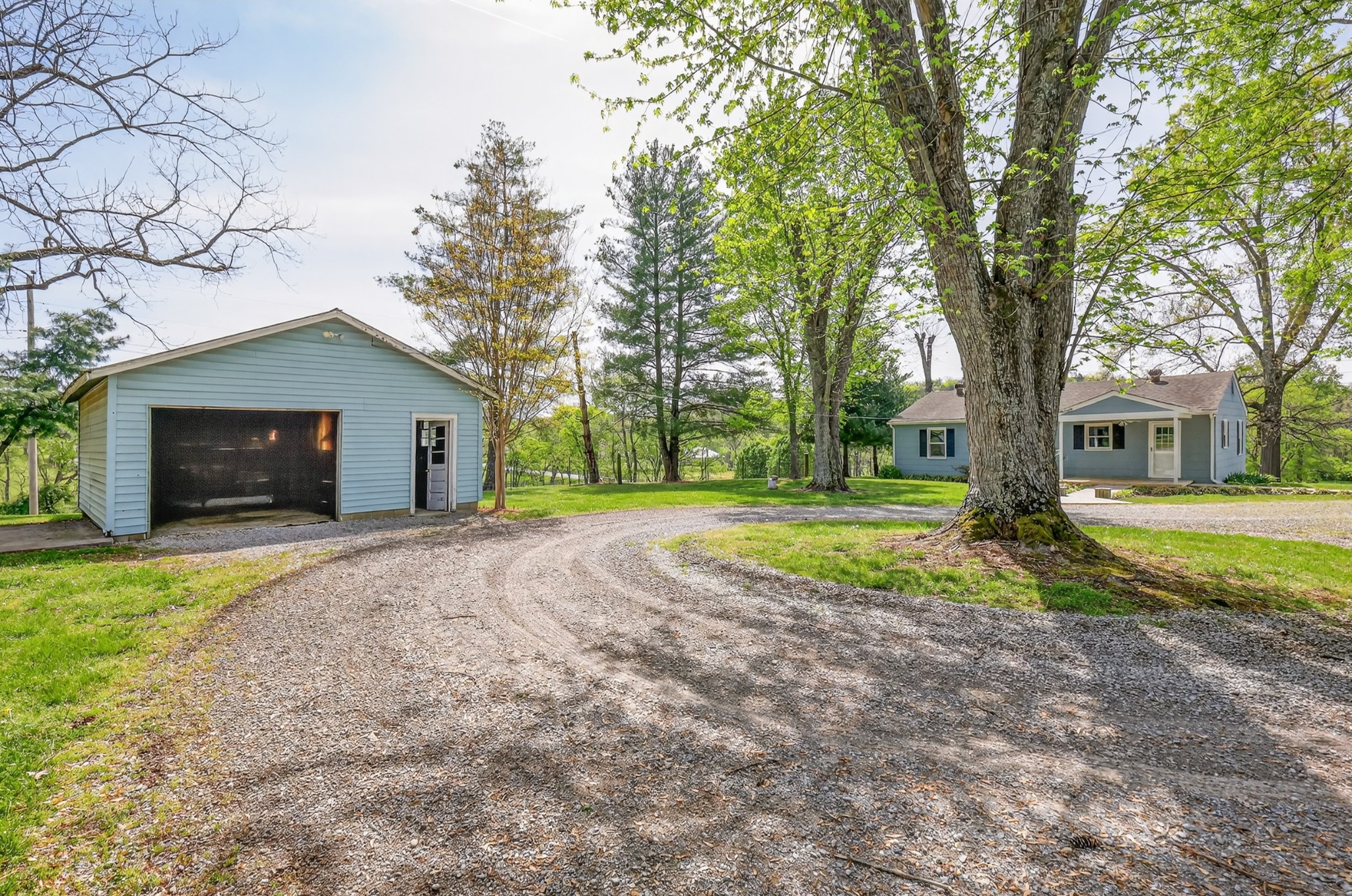 4676 Harpeth-Peytonsville Road Thompson's Station, TN 37179 - Photo 50 of 84 a view of a house with backyard and a tree