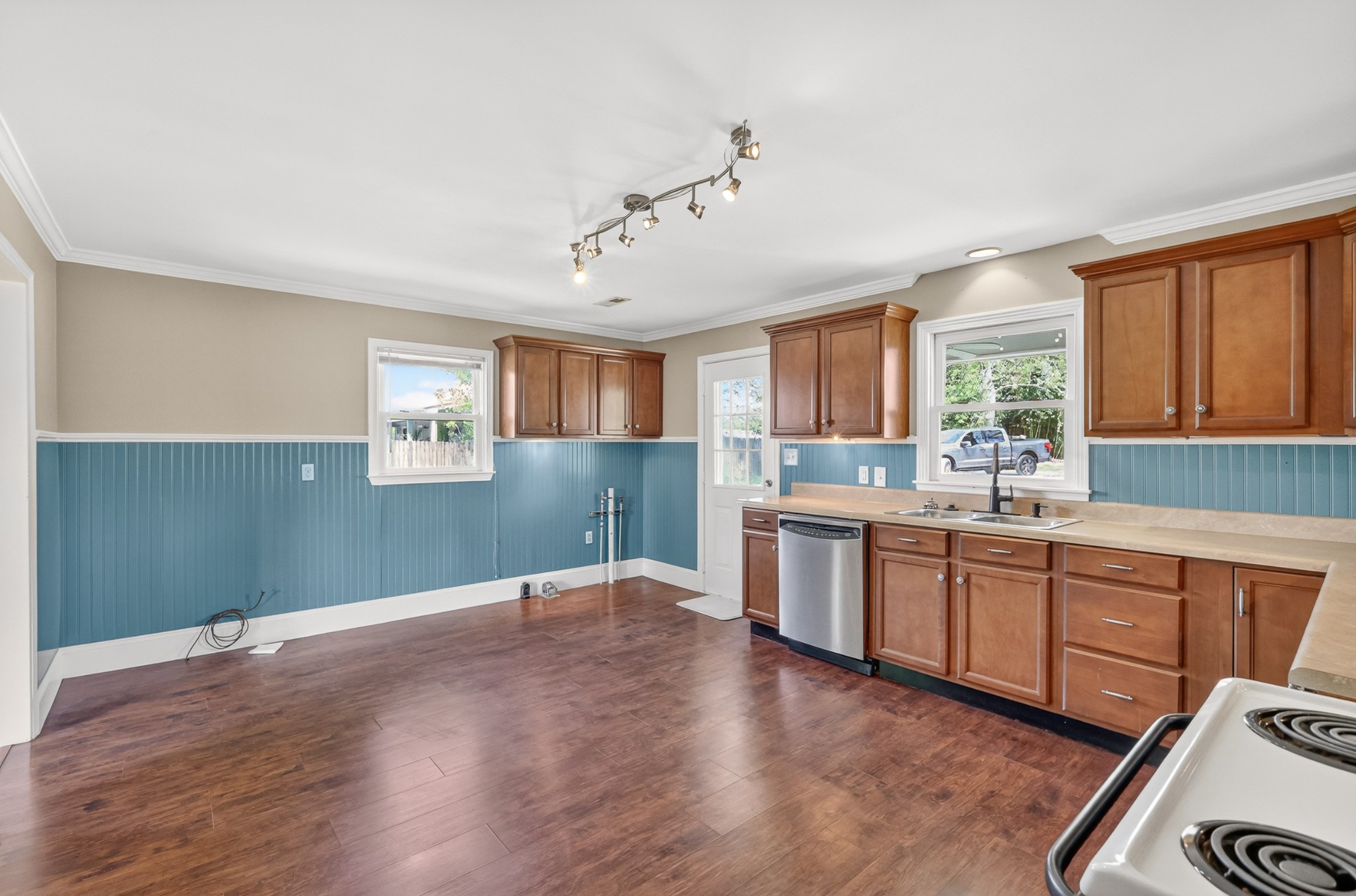4676 Harpeth-Peytonsville Road Thompson's Station, TN 37179 - Photo 63 of 84 a large kitchen with kitchen island a sink dishwasher a stove and white countertops with wooden floor