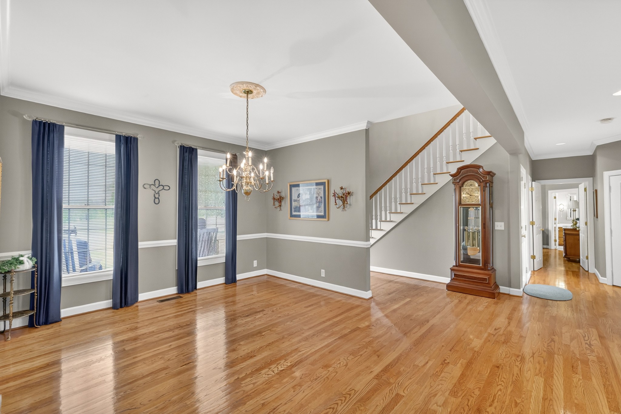 4676 Harpeth-Peytonsville Road Thompson's Station, TN 37179 - Photo 8 of 84 a view of a room with wooden floor staircase and a kitchen