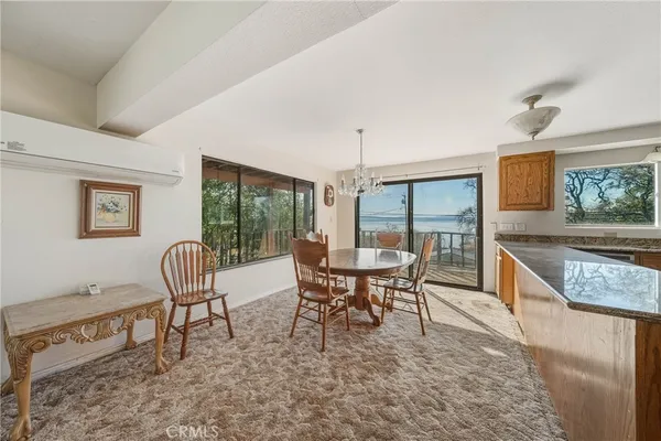 a large kitchen with stainless steel appliances granite countertop a large window a sink and cabinets