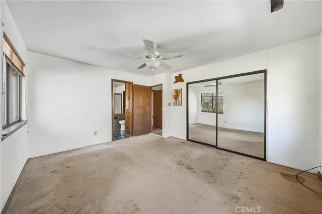 a large kitchen with kitchen island a large window a sink and stainless steel appliances