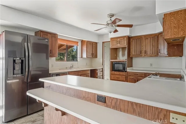 a view of an empty room with wooden floor and windows