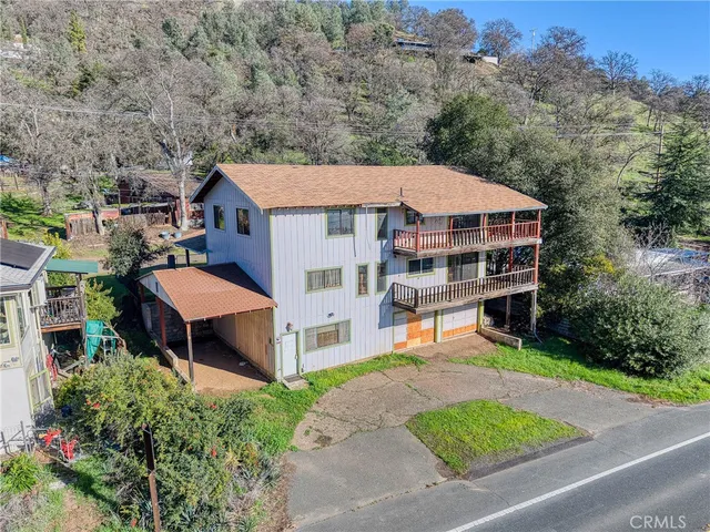 an aerial view of a house with a yard table and chairs