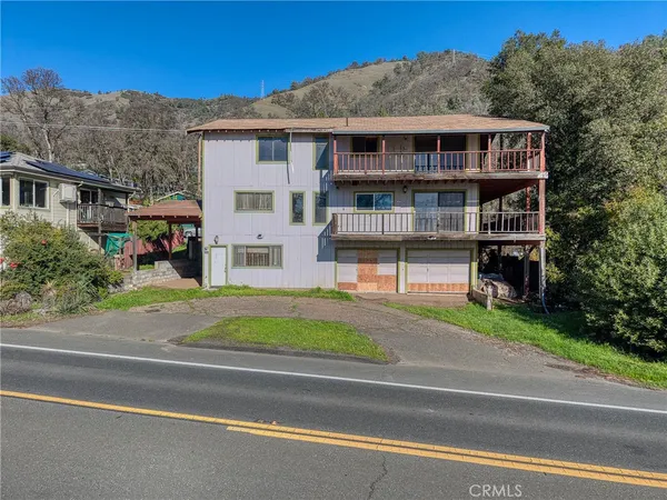 a view of a house with a wooden deck
