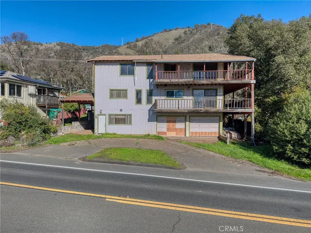 a view of a house with a wooden deck