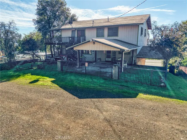 a backyard of a house with wooden fence and a yard