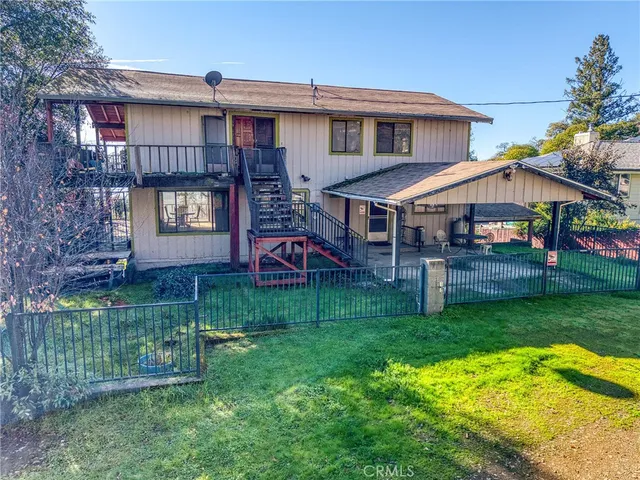 a view of a house with wooden fence