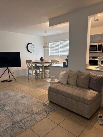 a living room with furniture a table and a window