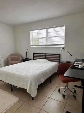 a bedroom with a bed and a desk