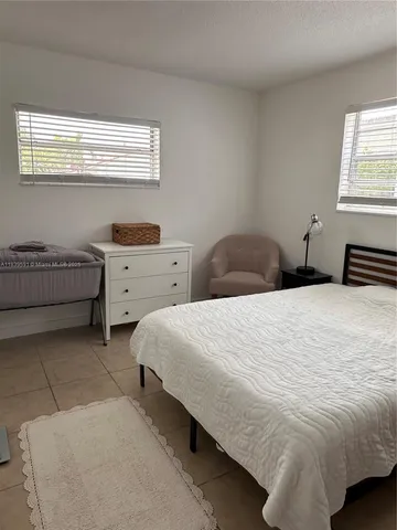 a bedroom with two beds and a window