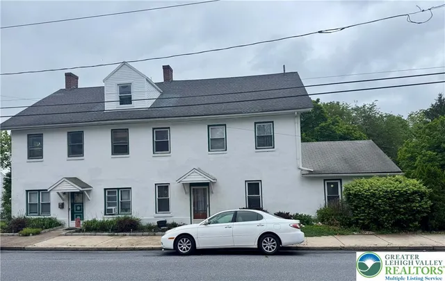 a view of multiple houses with a street