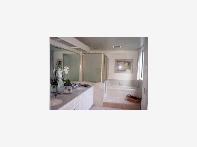 23 Bay Tree Lane Los Altos, CA 94022 - Photo 8 of 8 a en suite bathroom with a sink and mirror