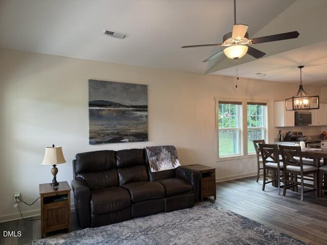 574 East Ridge Avenue Liberty, NC 27298 - Photo 9 of 28 a living room with furniture a chandelier and a dining table