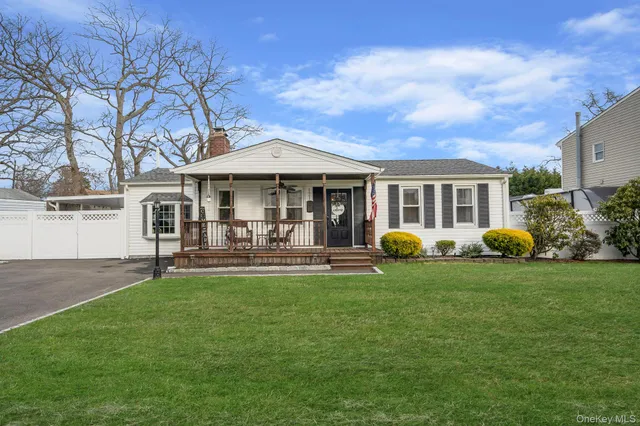 a front view of a house with patio and garden