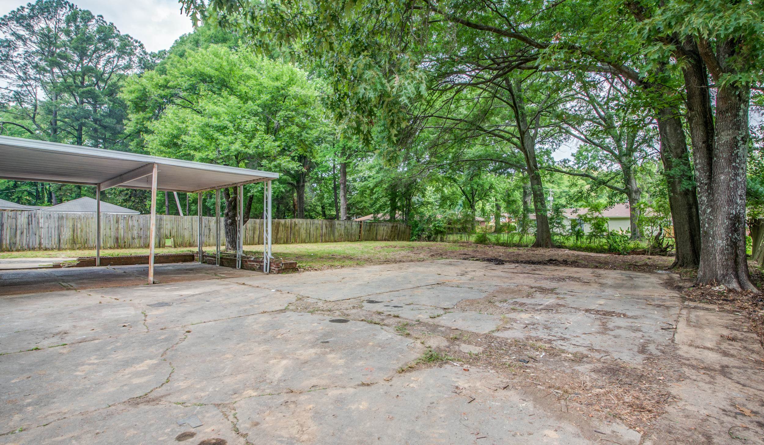 1110 Bluebird Road Memphis, TN 38116 - Photo 24 of 25 a view of backyard with wooden fence and large trees