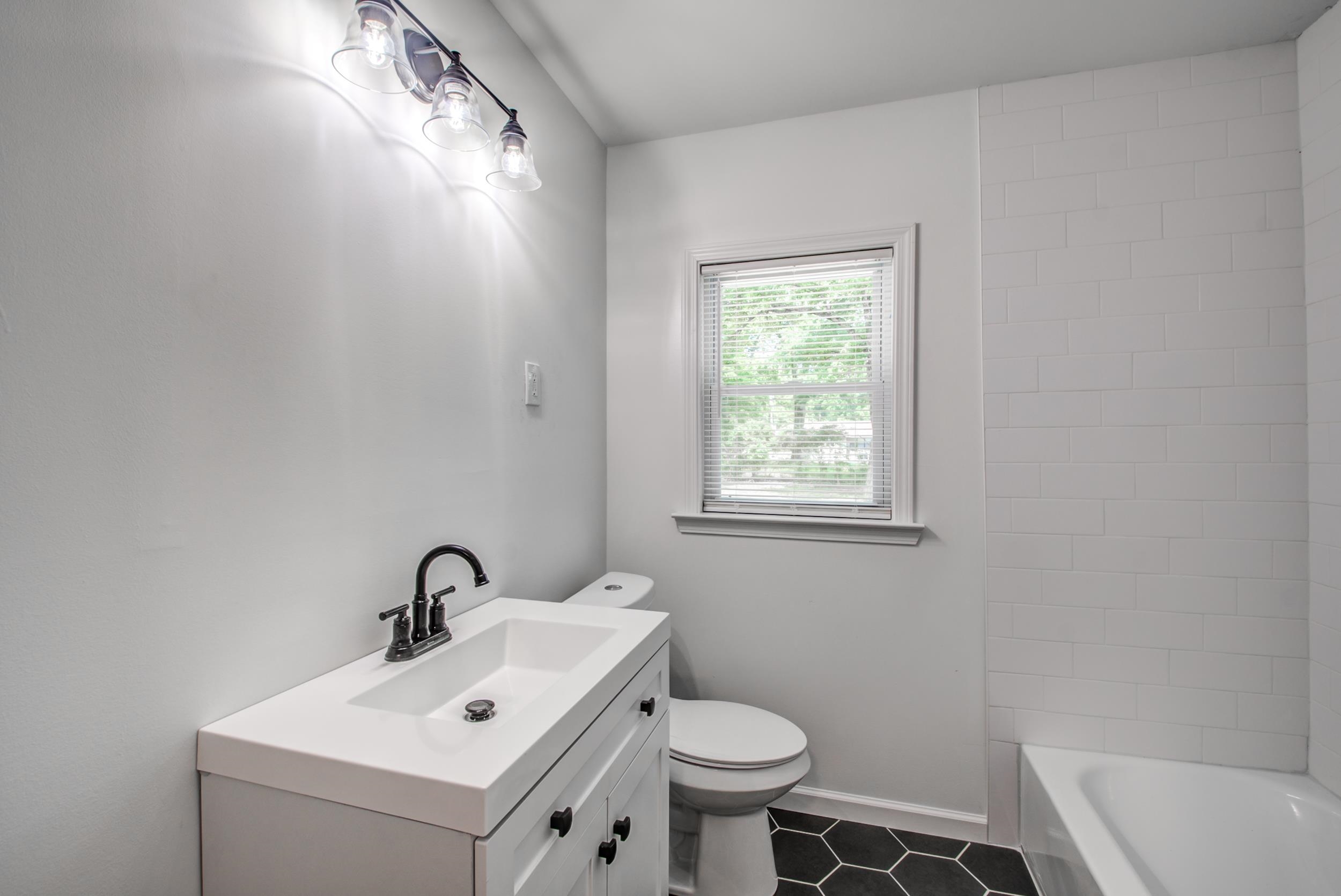 1110 Bluebird Road Memphis, TN 38116 - Photo 6 of 25 a bathroom with a sink toilet and a mirror