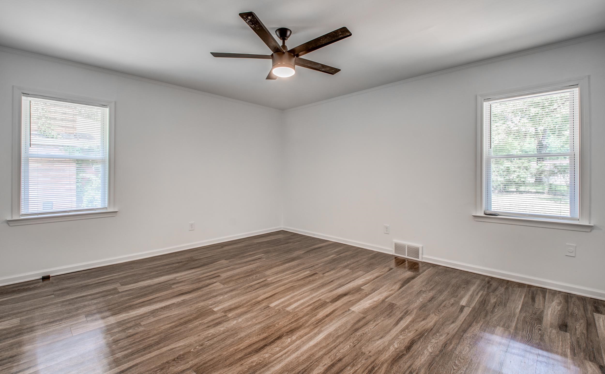 1110 Bluebird Road Memphis, TN 38116 - Photo 9 of 25 wooden floor in an empty room with a window