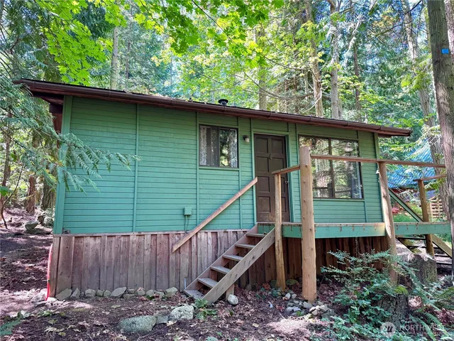 a green field with trees in front of it